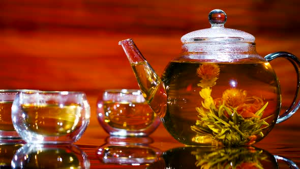 Herbal Tea Drinking Set. Transparent Cups and a Teapot with Flower Tea on a Beautiful Background.