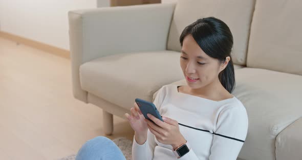 Woman look at mobile phone at home