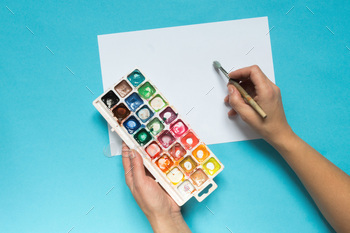 collection of accessories for artists. Canvas, oil paint tube, artistic brushes, palette, and hand / Photodune, Misc