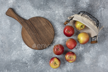 Bunch of fresh ripe apples out of wicker basket on marble surface / Photodune, Misc