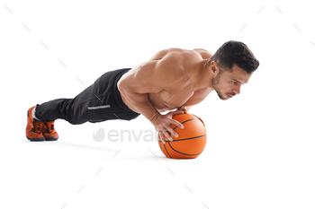 Muscular man doing push ups using basketball / Photodune, Misc