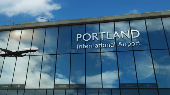 Airplane landing at Portland Oregon, USA airport mirrored in terminal