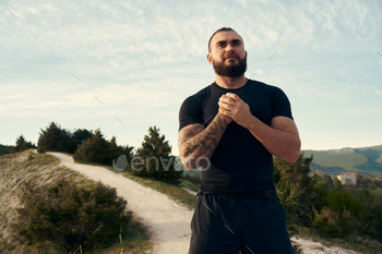 Male athlete warming up before start running in mountains / Photodune, Misc