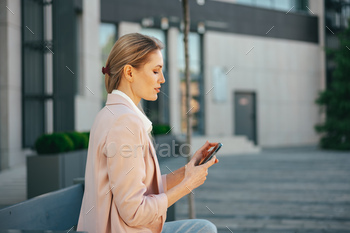Close up of a businesswoman using smartphone outdoors in the city / Photodune, Misc