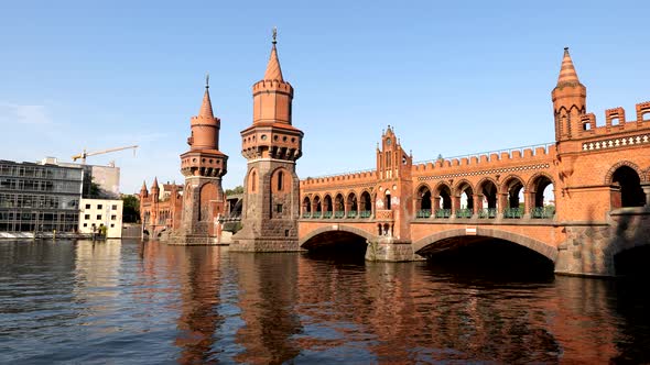 Oberbaum Bridge (Oberbaumbrucke) over River Spree at sunset in Berlin, Germany, North German Brick G