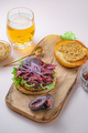 Hamburger with sliced pastrami served with lettuce on a freshly baked sesame bun over white - PhotoDune Item for Sale