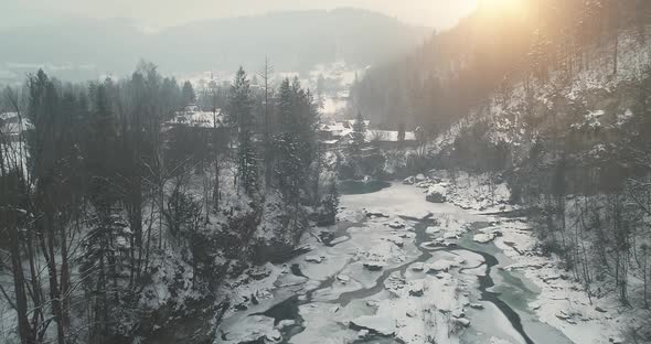 Sunset Over Mountain River at Snow Forest Slow Motion Aerial