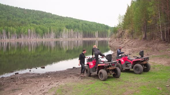 People Getting on Quad Bikes in Forest