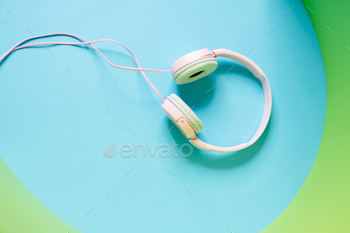 Overhead view of a pink wired headphones lying in the studio / Photodune, Misc