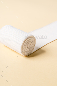The close-up shot of the unfolded bandage in the studio / Photodune, Misc