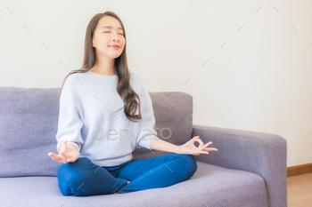 Portrait beautiful young asian woman meditation on sofa / Photodune, Misc
