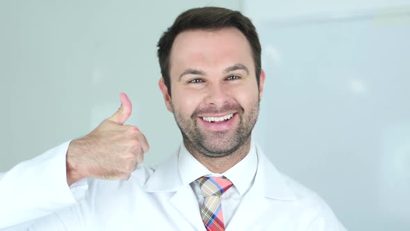 Portrait of Thumbs Up By Doctor in Clinic