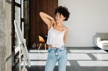 Smiling young curly woman standing / Photodune, Misc