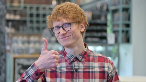 Positive Young Redhead Man with Thumbs Up Sign