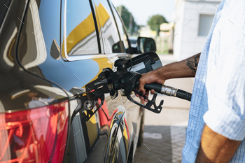 Man filling gasoline fuel in car at gas station / Photodune, Misc