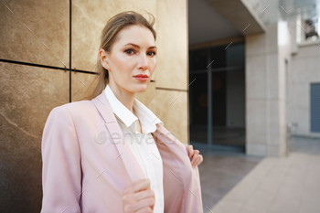 Stylish girl in jeans and white cotton blouse posing near gray wall / Photodune, Misc