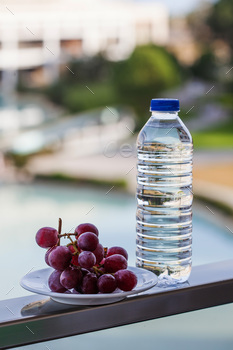 Plastic bottle with drinking water, next to the ripe grapes / Photodune, Misc