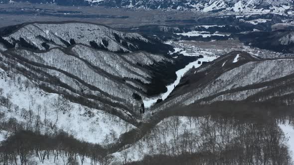 aerial of mountain landscape during winter in Nozawa Onsen Ski Resort in Japan
