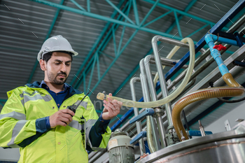 professional inspection control scientist in uniform are working for fruit juice production industry / Photodune, Misc