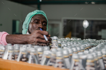 African American inspection worker engineer are work in drink water manufacturing factory / Photodune, Misc