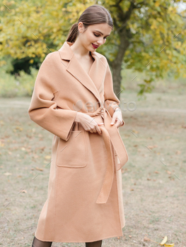 Young stylish woman in beige jacket having fun in the park / Photodune, Misc