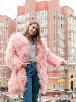 air and makeup posing in blue lama fur coat at rooftop. City fashion. Trendy girl