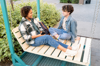 Teenage romantic couple in casualwear chatting outdoors / Photodune, Misc