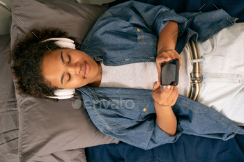 View of teenage girl listening to music in headphones / Photodune, Misc