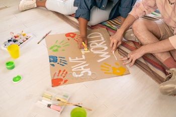 Contemporary teens sitting on the floor and drawing placard / Photodune, Misc