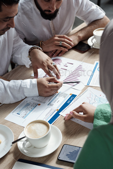 Group of Muslim business people discussing financial papers / Photodune, Misc