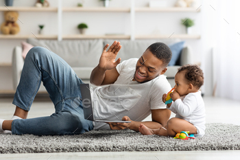 Black Dad And Infant Baby Making Video Call With Laptop At Home / Photodune, Misc