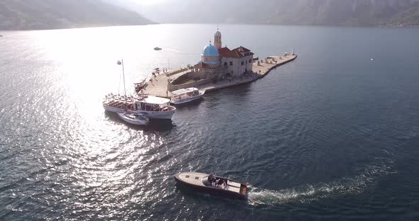 Motor Boat Sails on the Sea Past the Island of Gospa Od Skrpjela