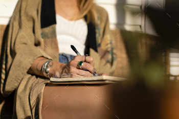 Relaxed woman writing in her journal / Photodune, Misc
