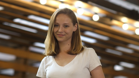 Young girl smiling charmingly at camera.