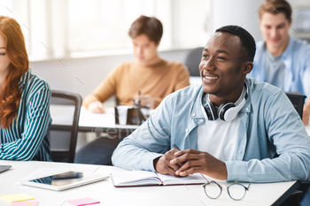 Portrait of black guy student listening to teacher at classroom / Photodune, Misc