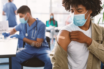 Black Guy Showing Vaccinated Arm With Adhesive Bandage In Hospital / Photodune, Misc