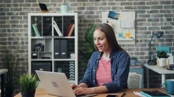 Attractive Girl Working with Laptop Laughing Clapping Hands Enjoying Success