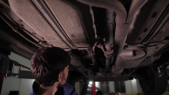 Automobile Mechanic During Car Underbody Check