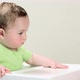 Baby boy sitting in highchair being fed - VideoHive Item for Sale
