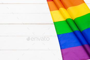 Gay pride flag on wooden table shot in studio / Photodune, Misc