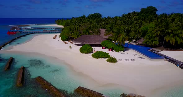 Beautiful fly over clean view of a white sand paradise beach and aqua turquoise water background