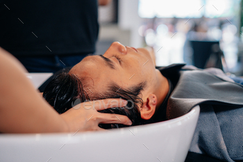 Barber washing head client in barbershop / Photodune, Misc