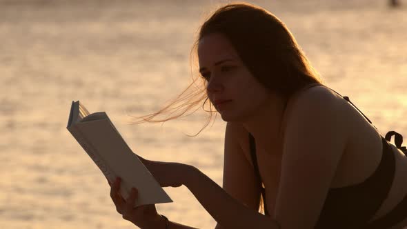 Silhouette Shot of a Beautiful Woman on Sunset Shot Against the Golden Ocean Water