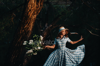 Portrait of a beautiful girl with long hair, a straw hat and a long summer dress with lilac flowers / Photodune, Misc