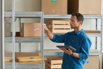 et in warehouse while doing inventory and managing small business, copy space