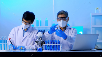Group of Asian scientists doing some research in the laboratory. / Photodune, Misc