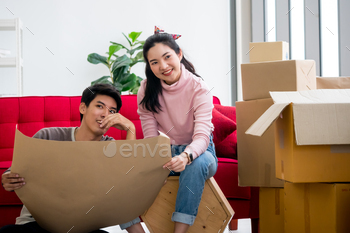Happy young couple moving to new house together. / Photodune, Misc