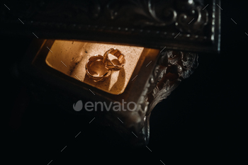 Gold wedding rings lie on an antique jewelry box. Wedding rings for ceremonies / Photodune, Misc