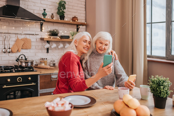Two mature grey-haired positive ladies making pictures / Photodune, Misc