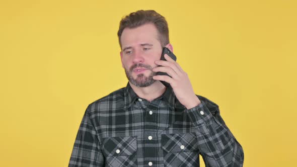 Portrait of Middle Aged Man Talking on Smartphone